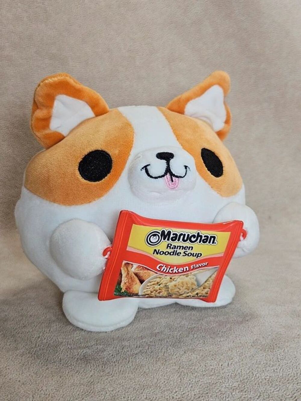 Snackles Benji the Corgi plush by ZURU holding ramen